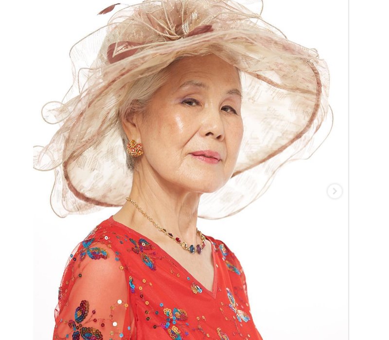 Chiếc mũ với thiết kế độc đáo cùng trang phục màu đỏ cam đem tới vẻ tràn đầy sức sống cho diện mạo bà Choi Soon Hwa.
